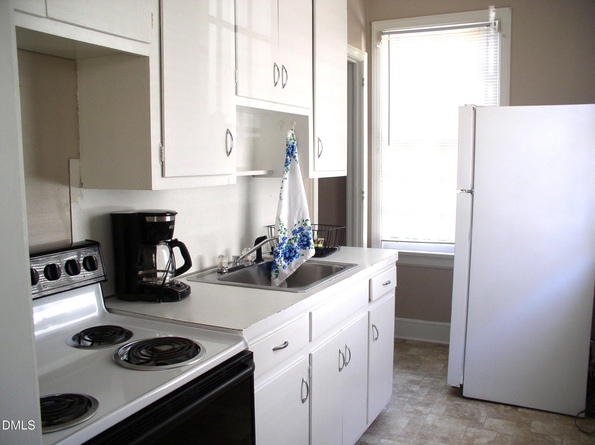 934 South Chestnut Street Henderson, NC 27536 - Photo 40 of 56 a kitchen with a refrigerator and a stove