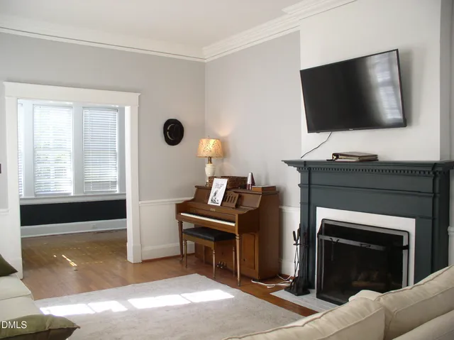 a living room with a flat screen tv and a fireplace