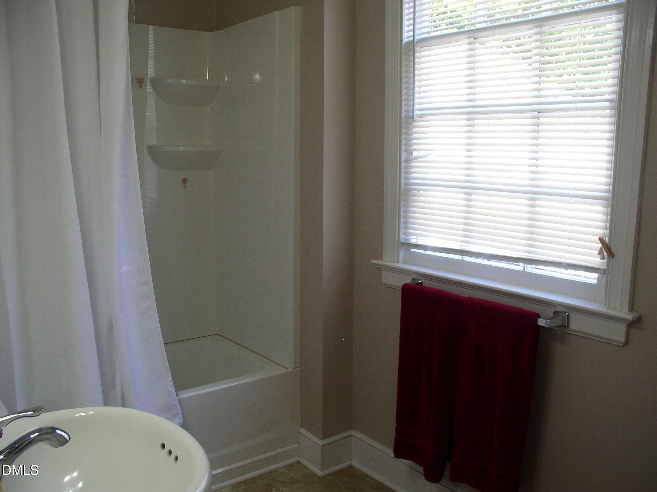 934 South Chestnut Street Henderson, NC 27536 - Photo 42 of 56 a bathroom with a sink a toilet and shower