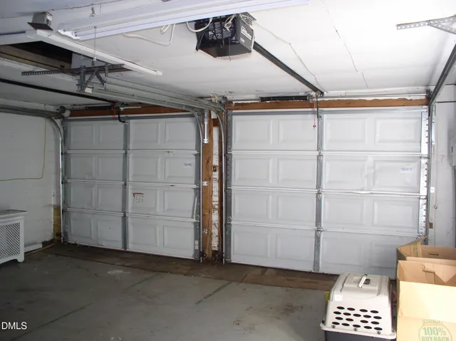 a view of a backyard with floor to ceiling window and wooden fence