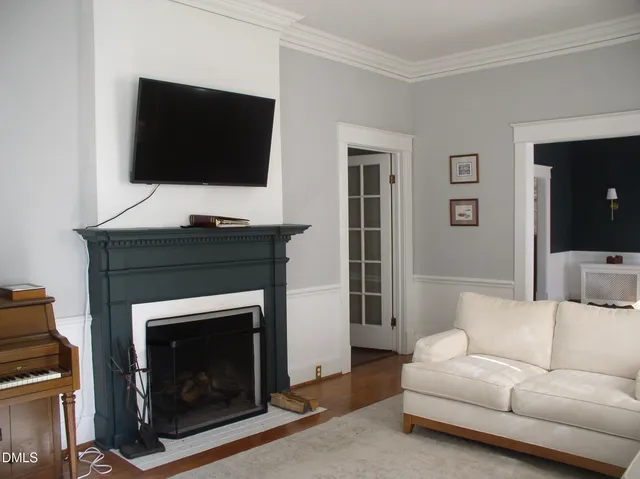 a living room with a fireplace and a flat screen tv