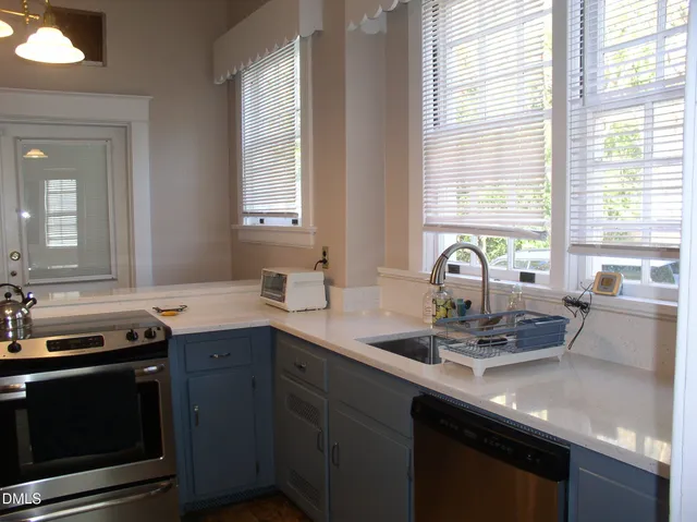 a kitchen with a sink stove and cabinets