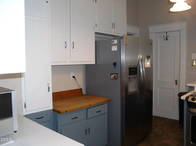a kitchen with stainless steel appliances granite countertop a refrigerator and a stove