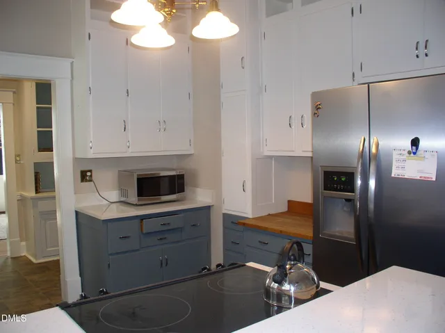 a kitchen with cabinets and stainless steel appliances
