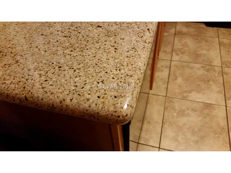 7701 West Robindale Road, Unit 145 Las Vegas, NV 89113 - Photo 22 of 34 Kitchen. Bull-nosed, granite slab countertops
