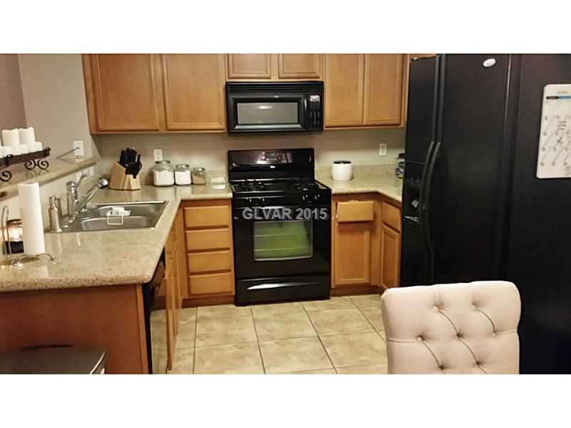 7701 West Robindale Road, Unit 145 Las Vegas, NV 89113 - Photo 8 of 34 Kitchen. Custom cabinets, granite/tile, all black appliances, recessed lighting.