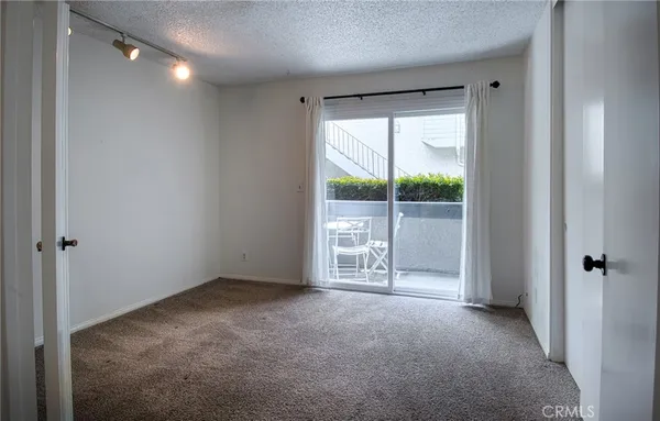 a view of an empty room with glass door