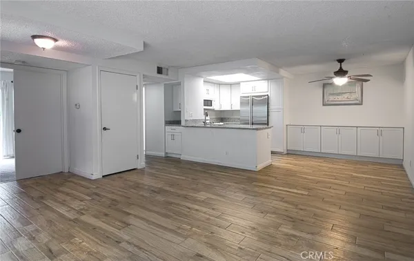 a view of a kitchen with a sink and cabinets