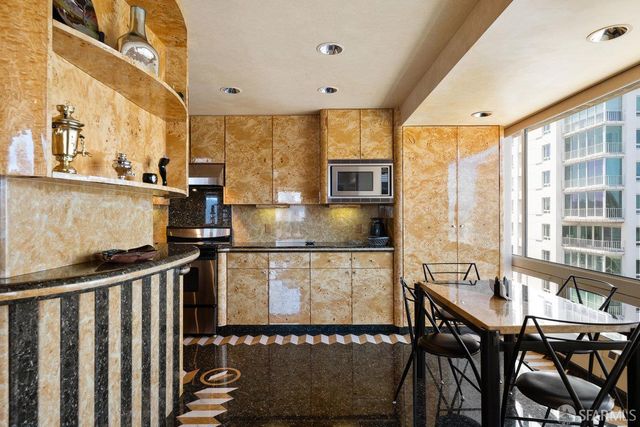 a living room with furniture a window and wooden floor