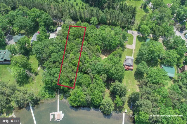 an aerial view of a houses with outdoor space and river