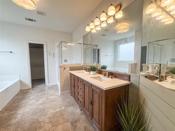 a view of an empty room and a chandelier fan