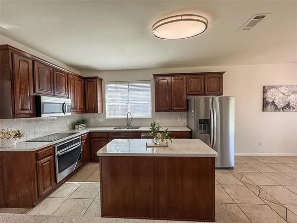 a kitchen with a sink stove and refrigerator
