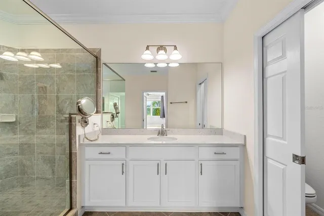 a bathroom with a shower a sink and a mirror