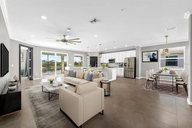 a living room with furniture and view of kitchen