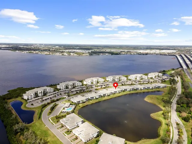 an aerial view of a house with outdoor space and lake view