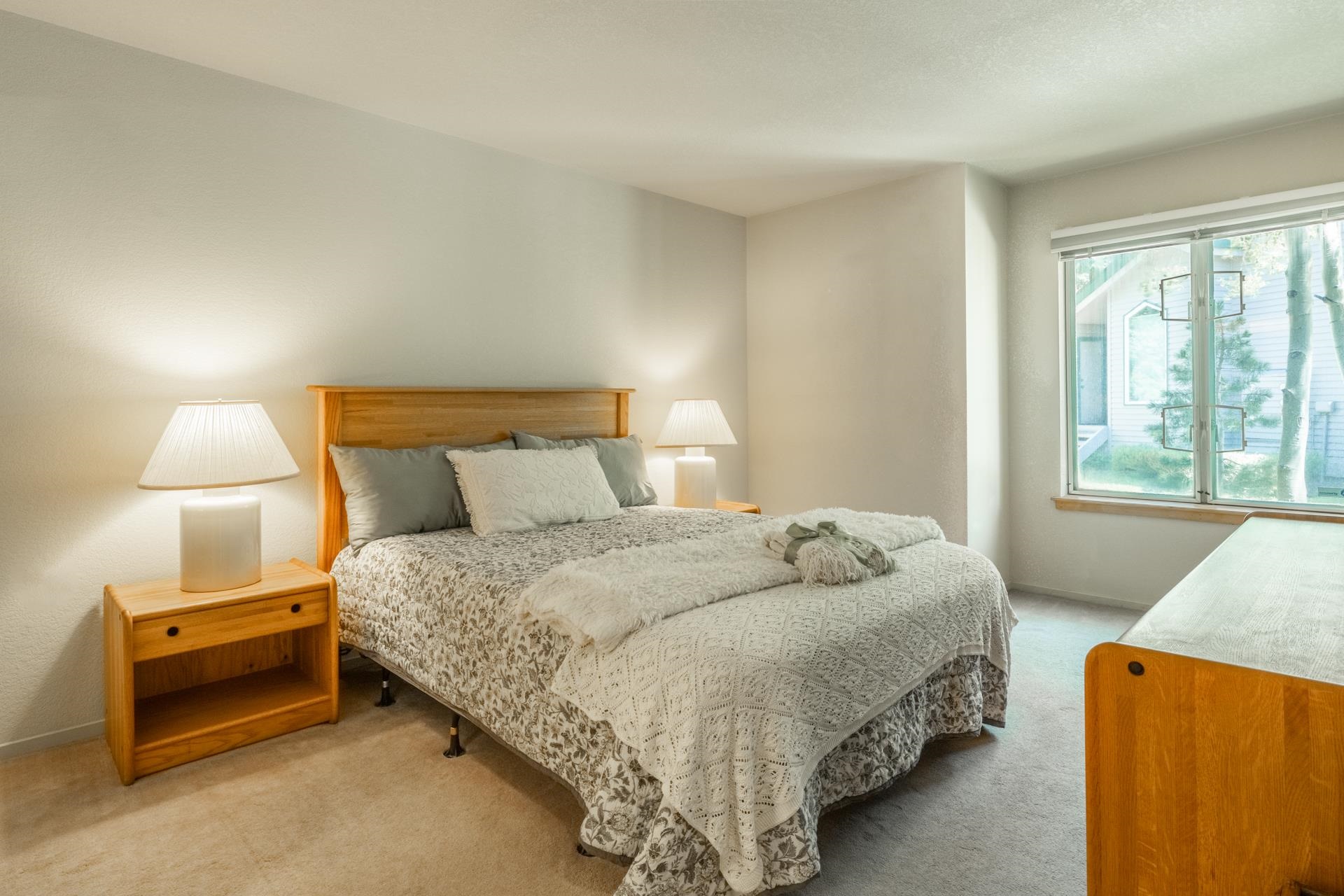 609 Golden Creek Road, Unit 609 Mammoth Lakes, CA 93546 - Photo 7 of 42 Carpeted bedroom featuring a large window, neutral wall paint, and a built-in window sill