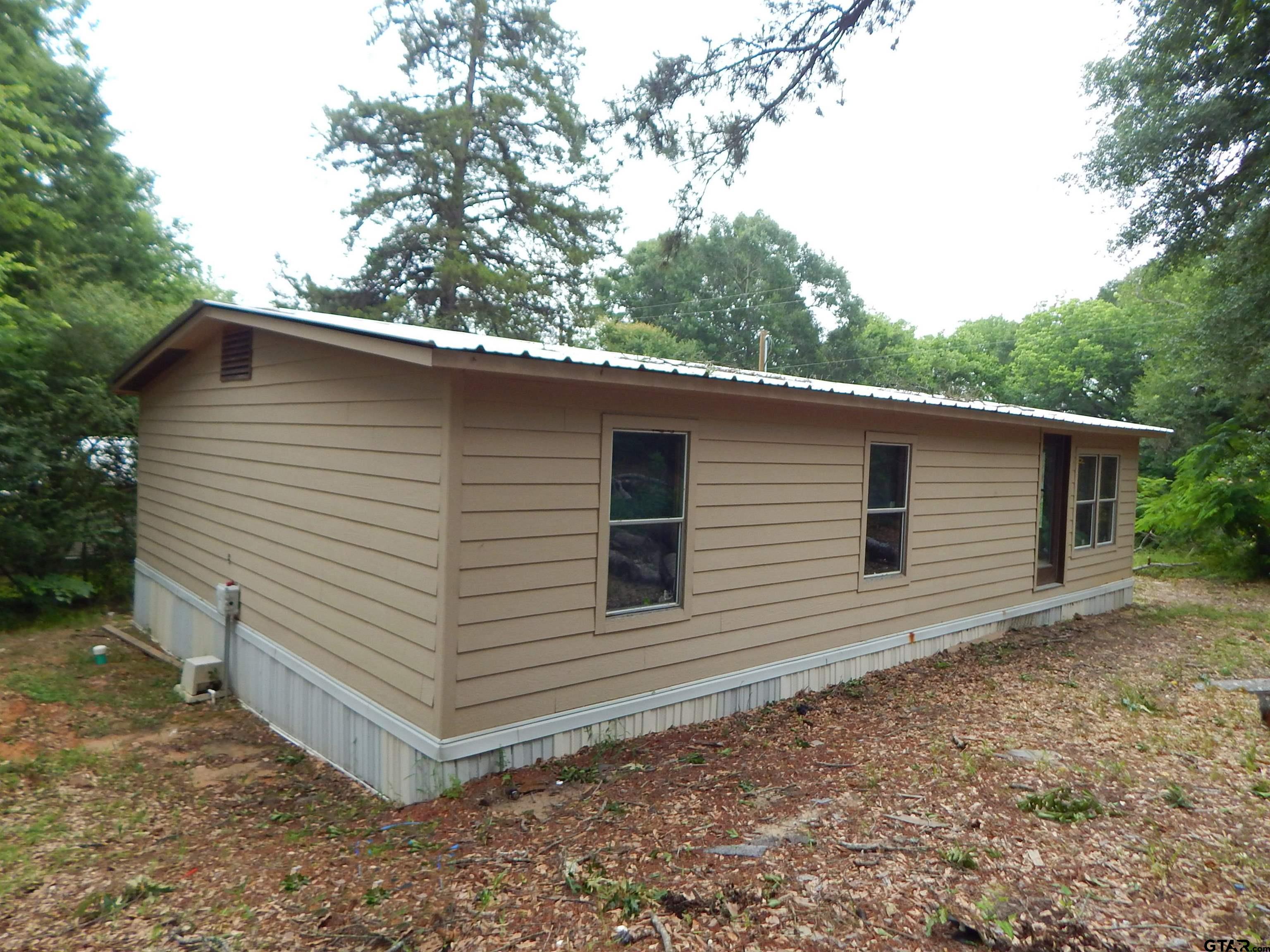 228 Gage Road Big Sandy, TX 75755 - Photo 10 of 13 a view of a house with a backyard