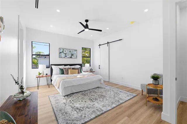 a bedroom with a large bed and a window