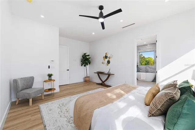 a bathroom with a tub a sink and mirror