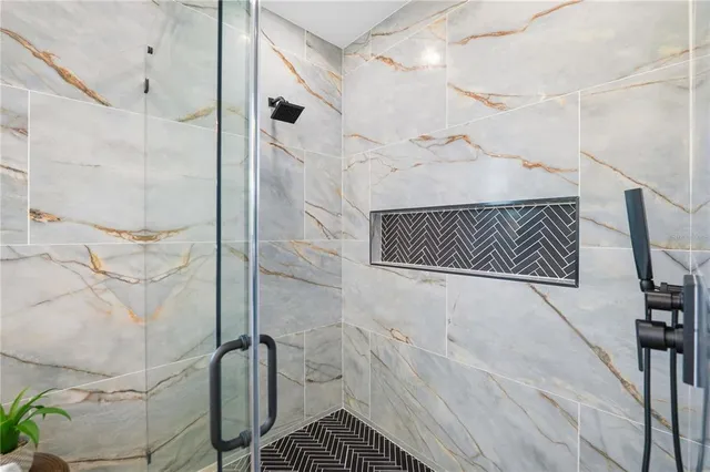 a white toilet sitting next to a white wall