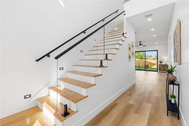 a view of entryway and hall with wooden floor