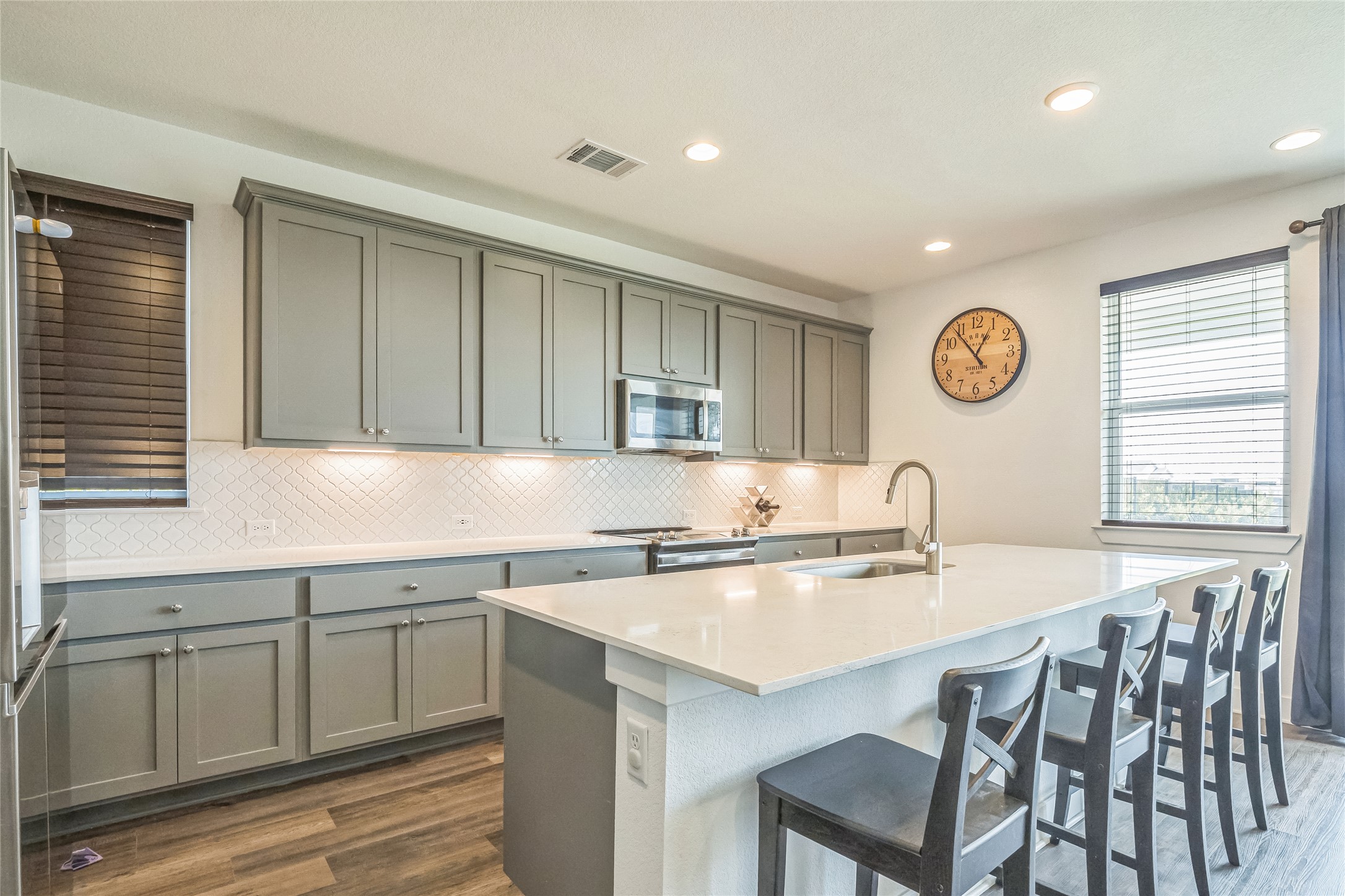 3706 Mesquite Vly Road Georgetown, TX 78628 - Photo 3 of 30 Kitchen with stainless steel appliances, a sink, dark wood-style floors, backsplash, and recessed lighting
