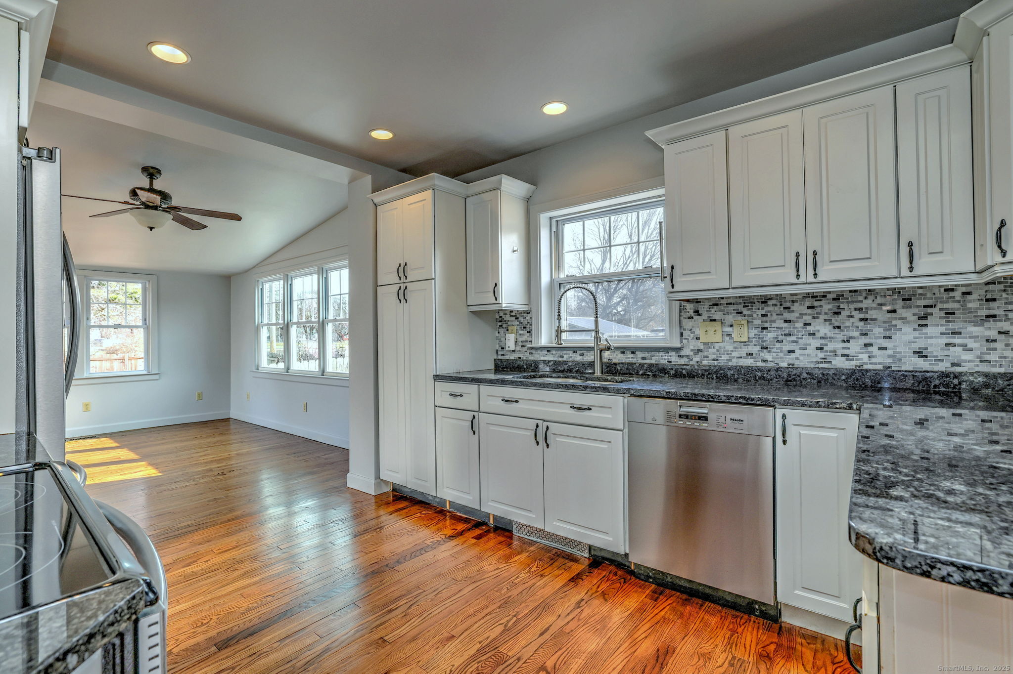 113 Chester Street Hamden, CT 06514 - Photo 11 of 40 a kitchen with sink cabinets and wooden floor