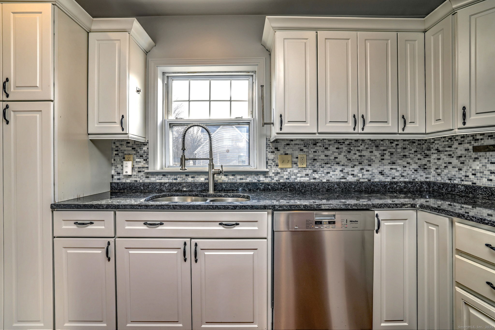 113 Chester Street Hamden, CT 06514 - Photo 12 of 40 a kitchen with granite countertop white cabinets and white appliances