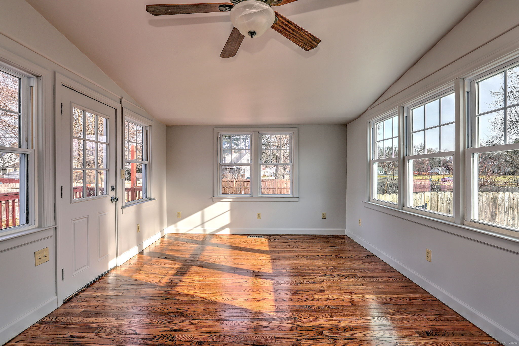 113 Chester Street Hamden, CT 06514 - Photo 18 of 40 a view of an empty room with a window and wooden floor
