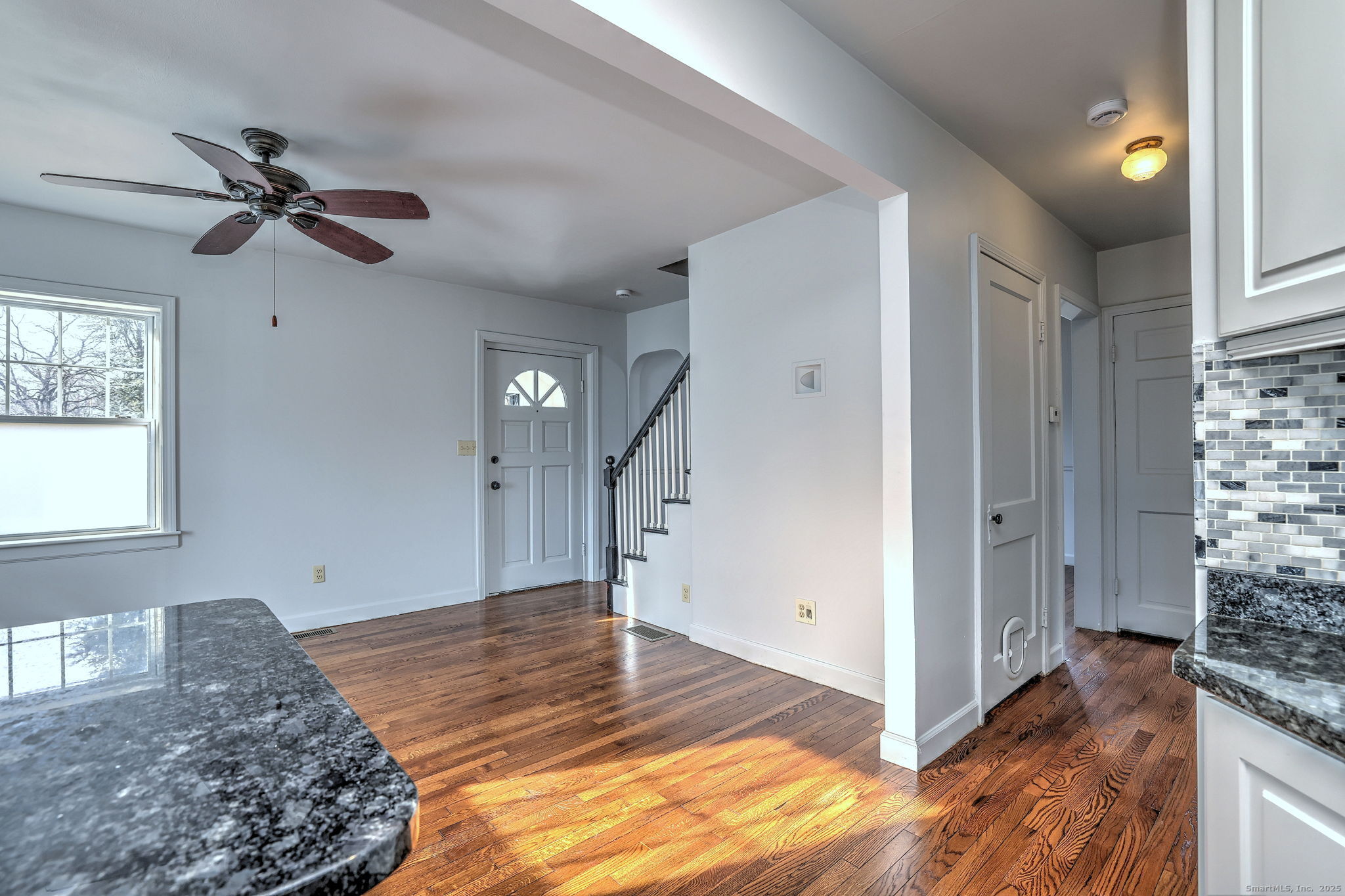 113 Chester Street Hamden, CT 06514 - Photo 21 of 40 a view of a livingroom with wooden floor and staircase