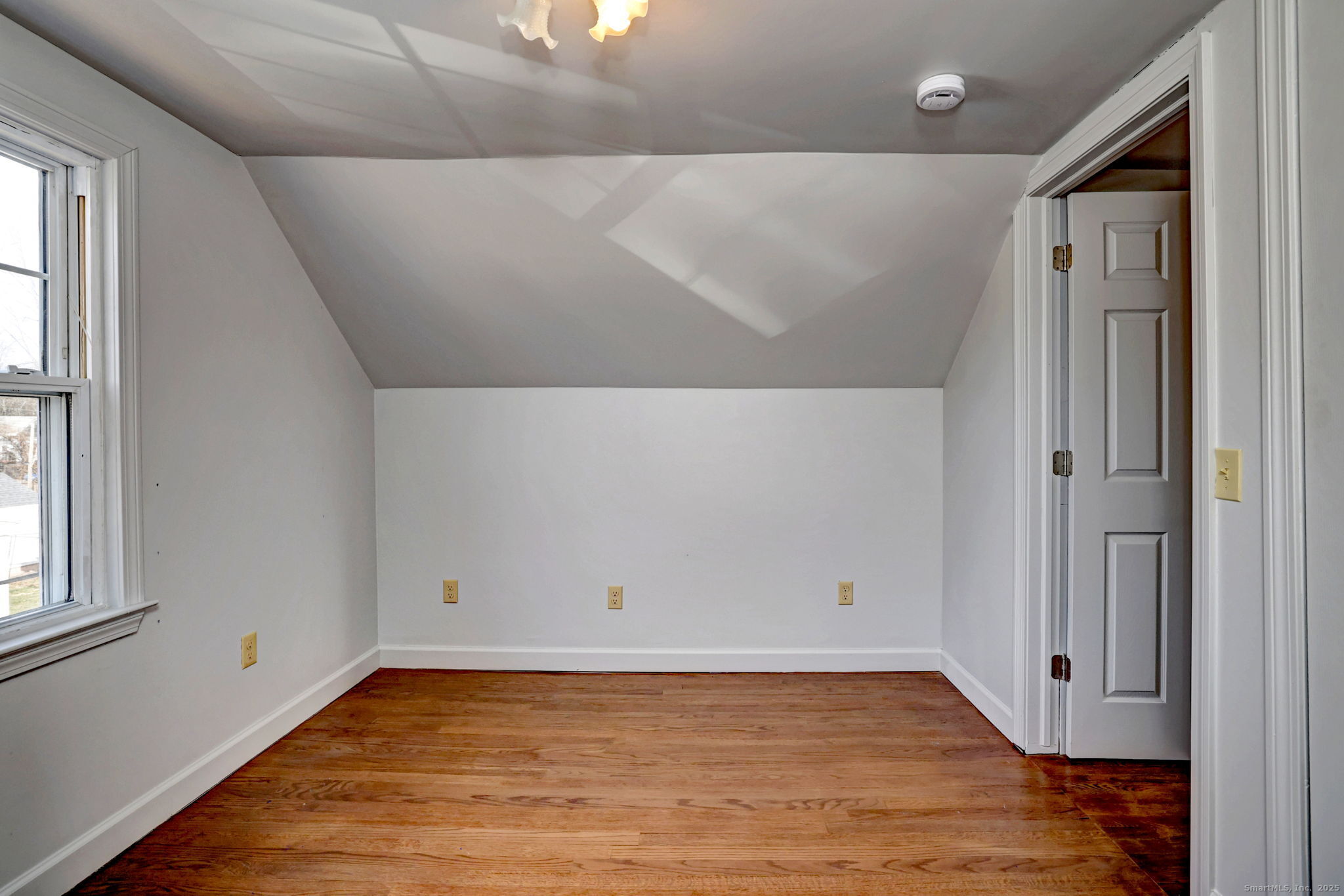 113 Chester Street Hamden, CT 06514 - Photo 35 of 40 an empty room with wooden floor and window