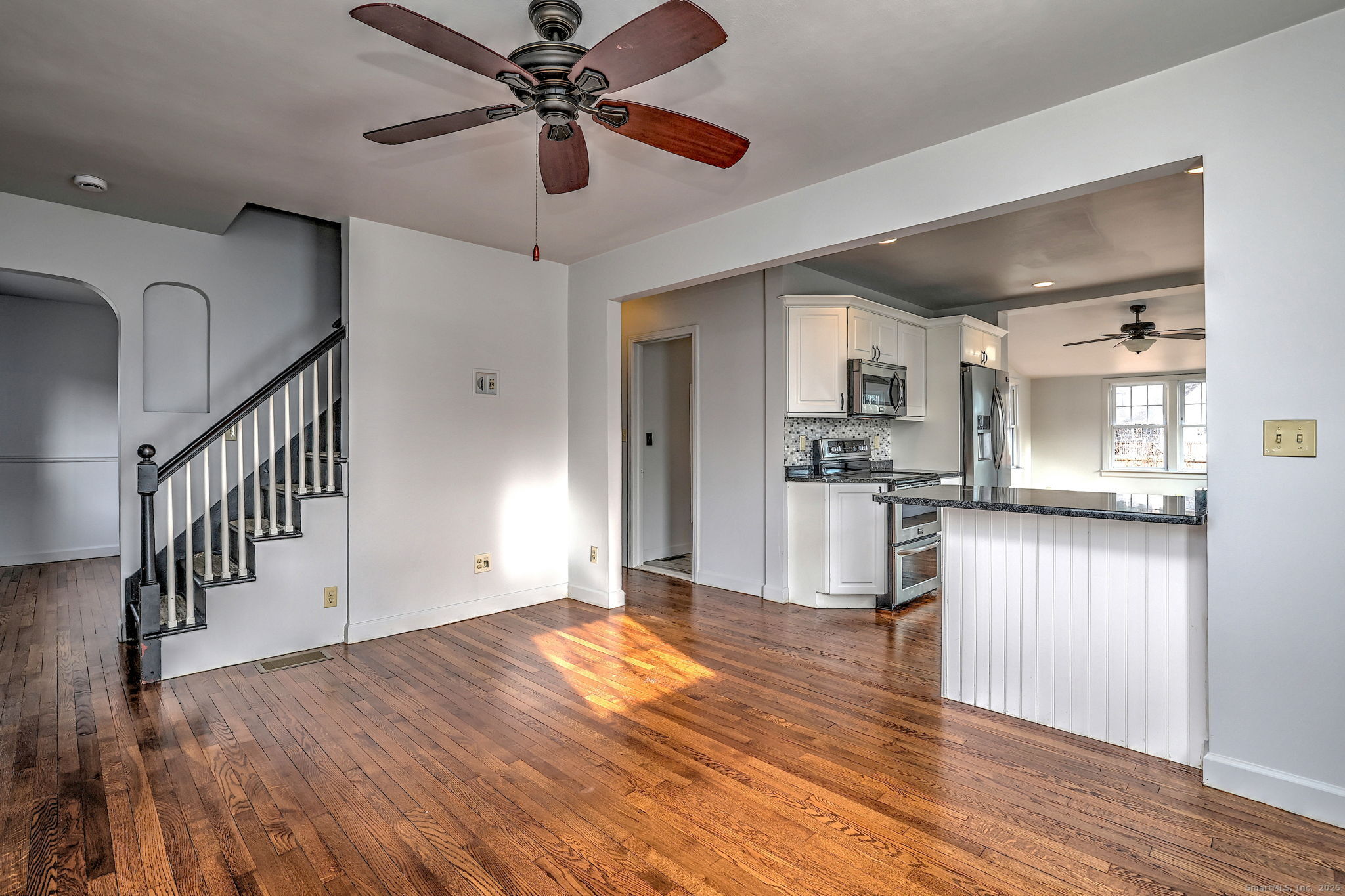 113 Chester Street Hamden, CT 06514 - Photo 5 of 40 a view of empty room with wooden floor and fan
