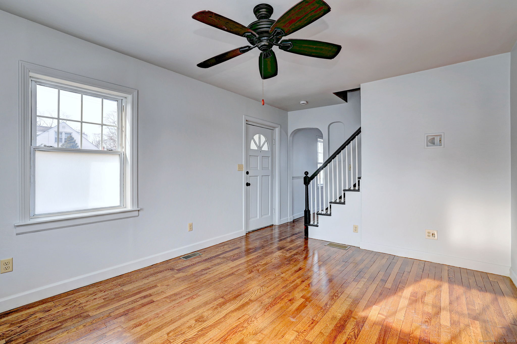 113 Chester Street Hamden, CT 06514 - Photo 6 of 40 a view of empty room with wooden floor and fan
