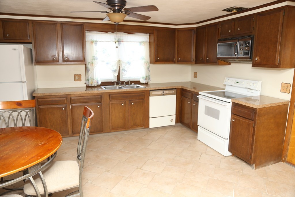 35 Long Terrace Springfield, MA 01104 - Photo 3 of 22 a kitchen with a stove a sink and a refrigerator