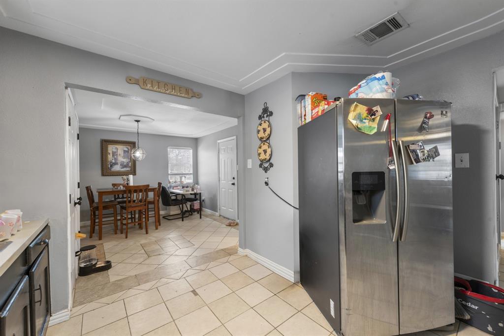 508 North Dick Price Road Kennedale, TX 76060 - Photo 13 of 34 a kitchen with stainless steel appliances granite countertop a refrigerator and a sink