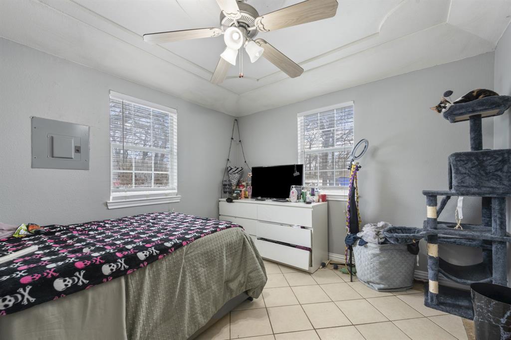 508 North Dick Price Road Kennedale, TX 76060 - Photo 18 of 34 a bedroom with furniture and a flat screen tv