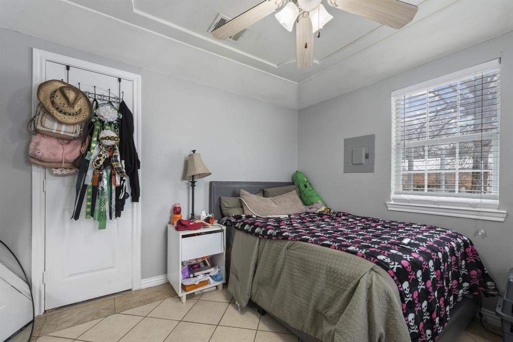 508 North Dick Price Road Kennedale, TX 76060 - Photo 19 of 34 a bedroom with a bed and a chandelier