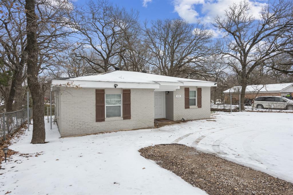 508 North Dick Price Road Kennedale, TX 76060 - Photo 2 of 34 a front view of a house with a yard covered in snow