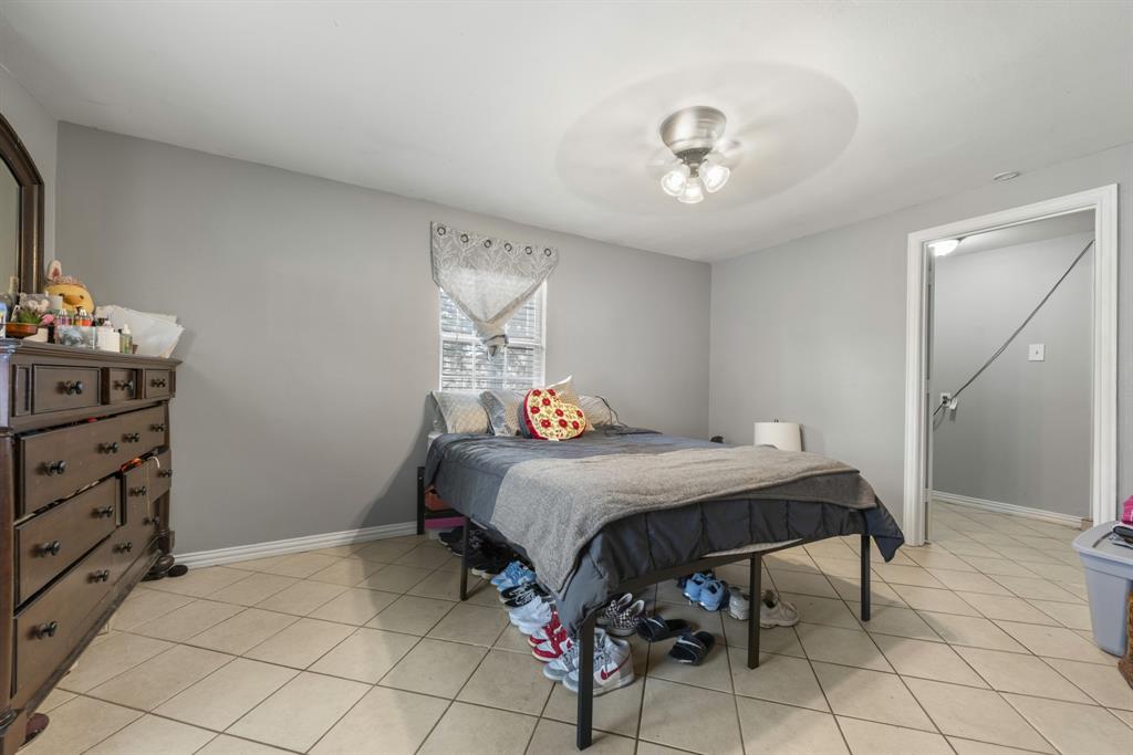 508 North Dick Price Road Kennedale, TX 76060 - Photo 21 of 34 a bedroom with a bed and a chandelier