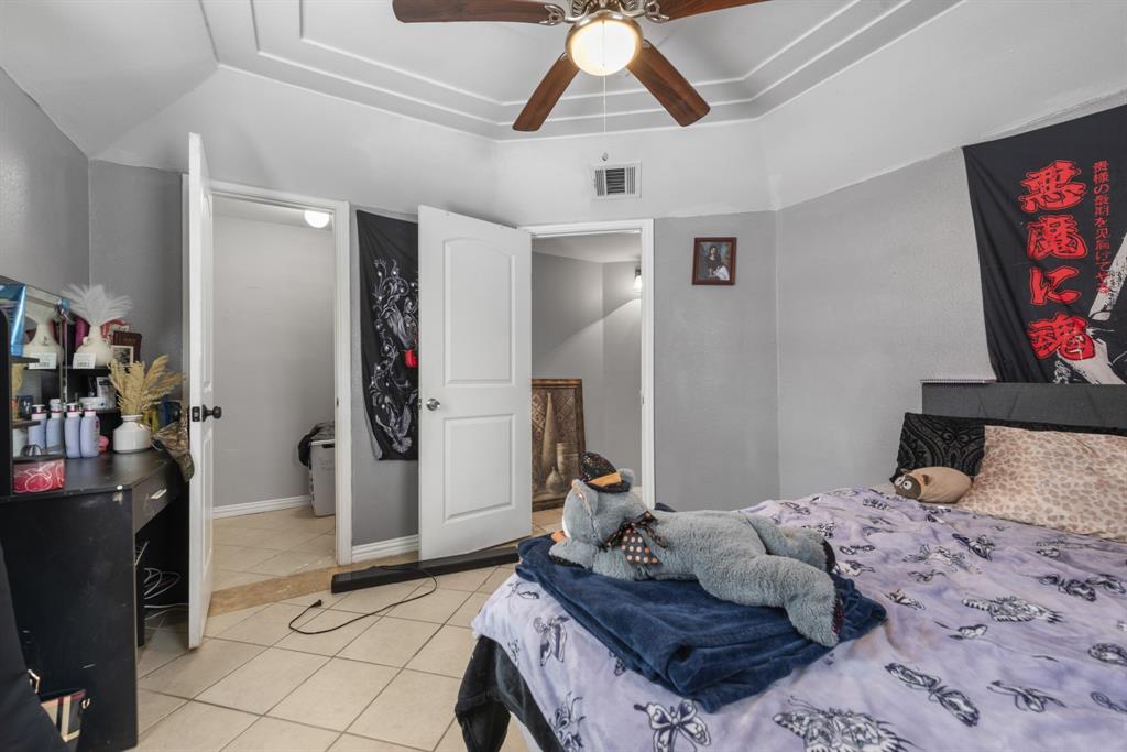 508 North Dick Price Road Kennedale, TX 76060 - Photo 23 of 34 a bedroom with a bed and a flat screen tv