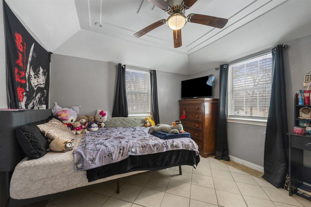 508 North Dick Price Road Kennedale, TX 76060 - Photo 24 of 34 a bedroom with a bed couch and flat screen tv