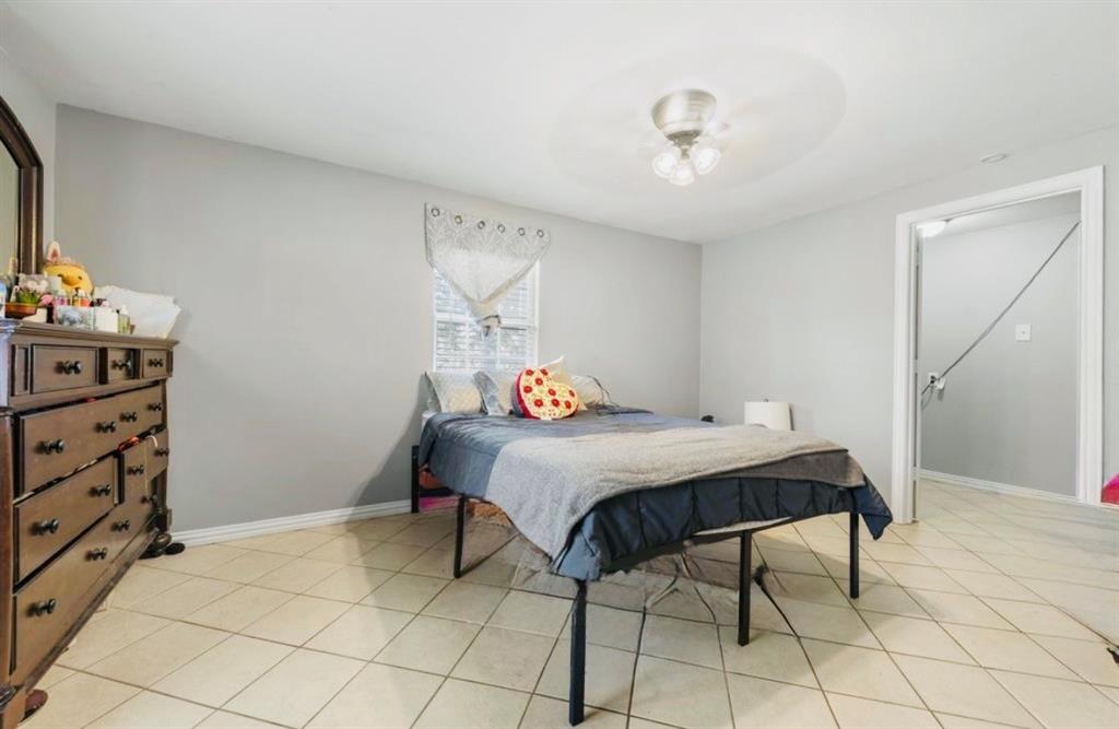 508 North Dick Price Road Kennedale, TX 76060 - Photo 5 of 9 a bedroom with a bed and a cabinets