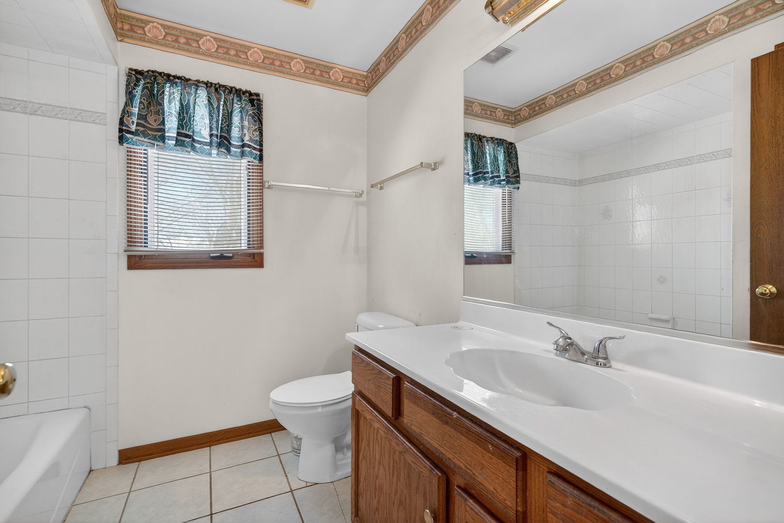 4448 Maple Avenue Matteson, IL 60443 - Photo 22 of 26 a bathroom with a sink and a mirror
