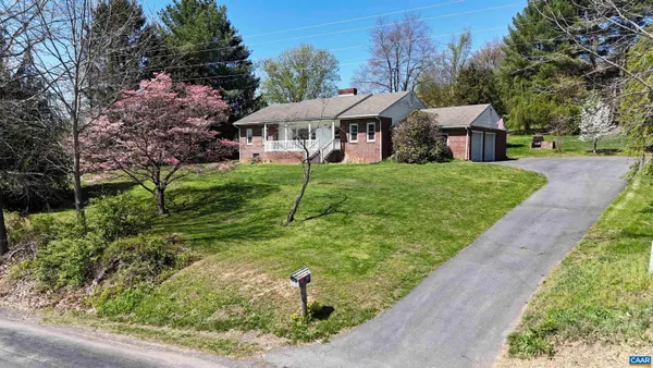 a front view of house with yard and outdoor seating