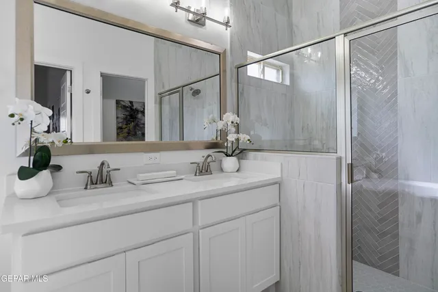 a bathroom with a double vanity sink and a mirror