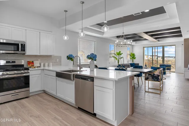 a kitchen with lots of counter top space and a wooden floor