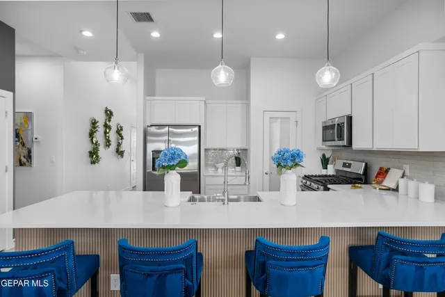 a kitchen with counter top space cabinets and appliances