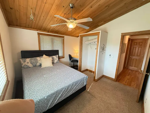 a bedroom with a bed and a large mirror