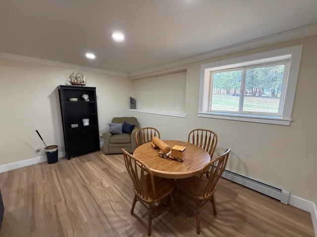 a dining room with furniture and window