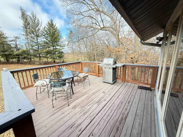 a view of balcony with wooden floor and outdoor seating